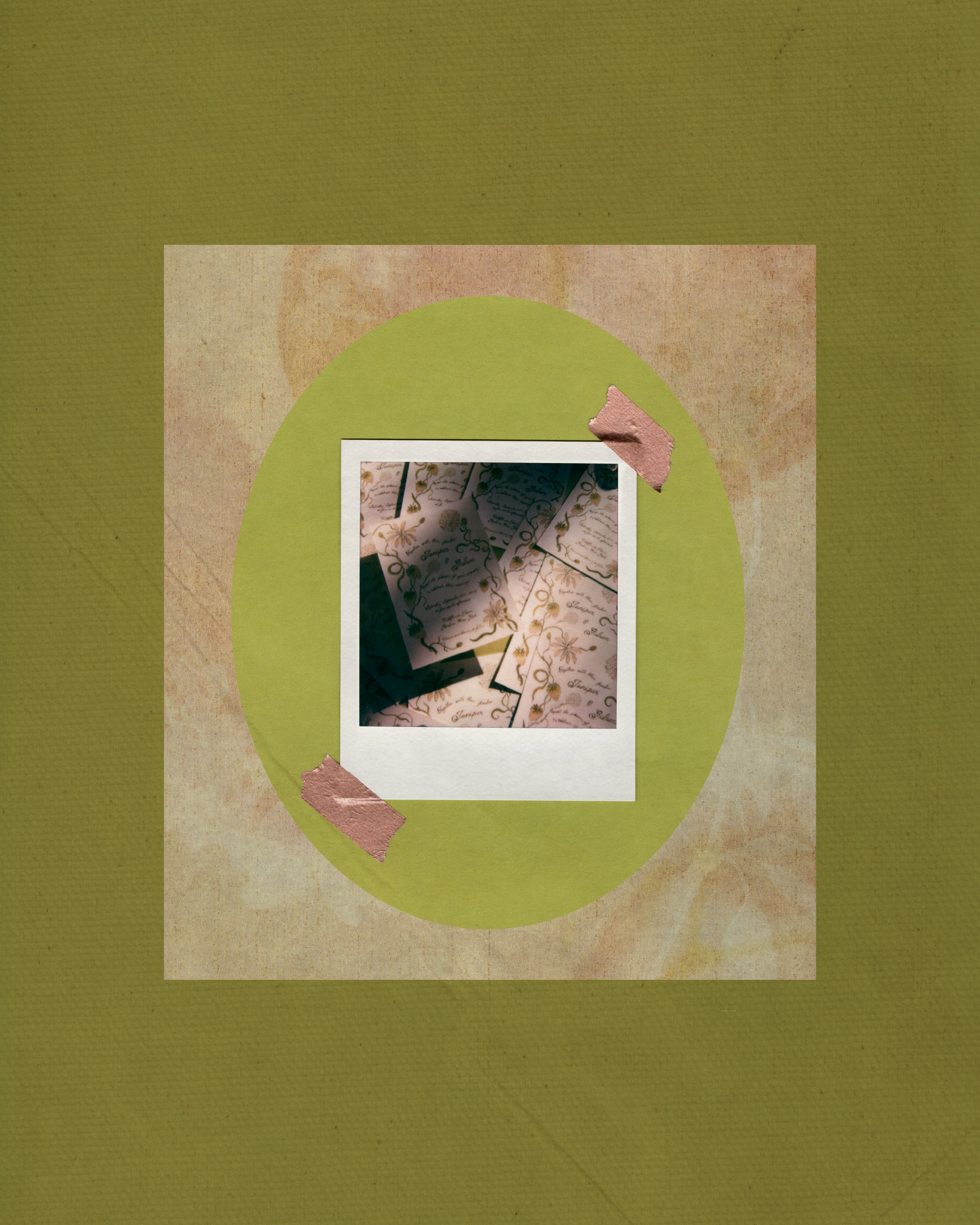 Colored photo of small paper tags with cursive writing and decorative gold designs on a green and beige background, with pink tape details.