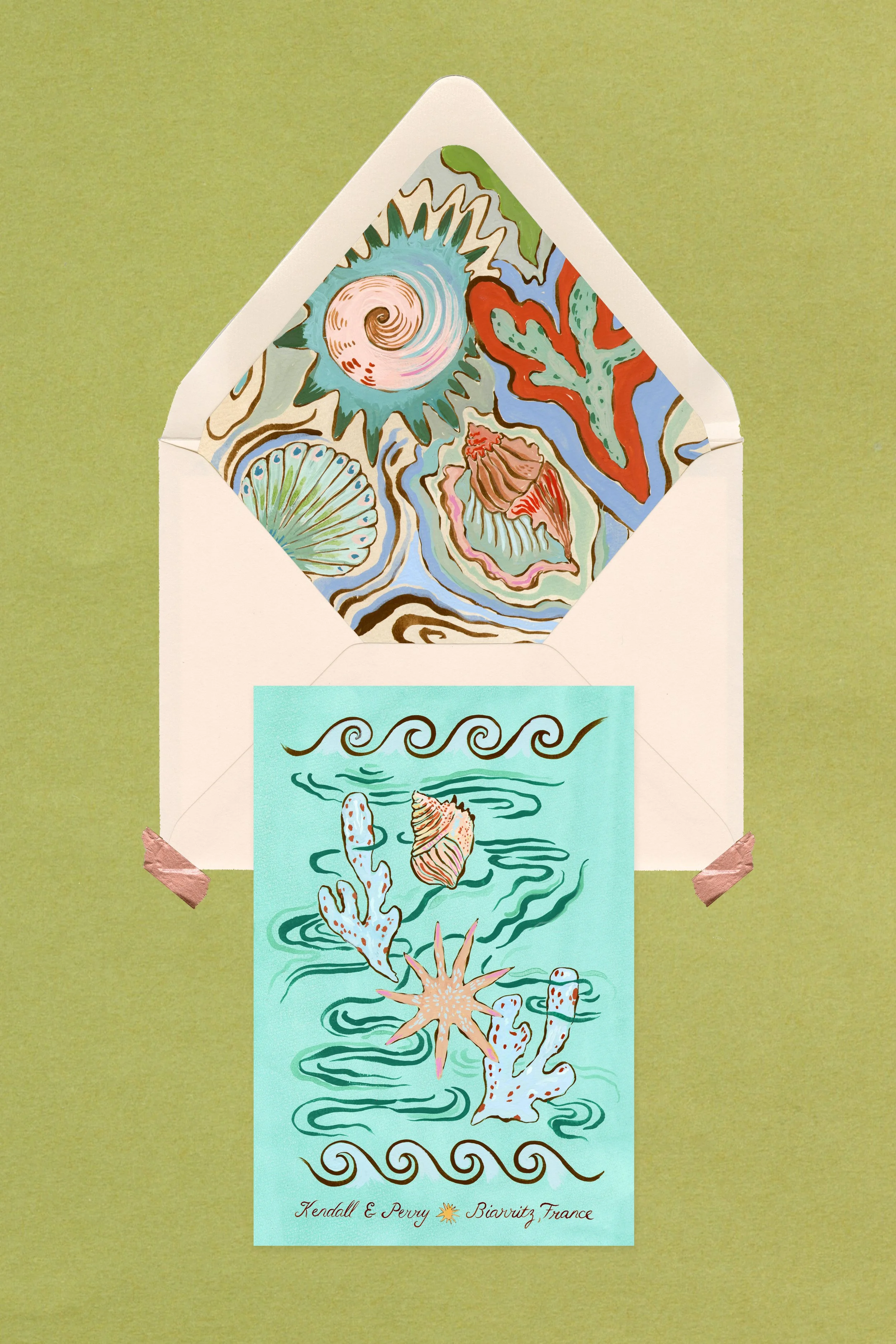 Artwork featuring sea-themed illustrations inside an open envelope, with a postcard showing underwater effects, coral, shells, and waves on a blue background, taped to a green surface.