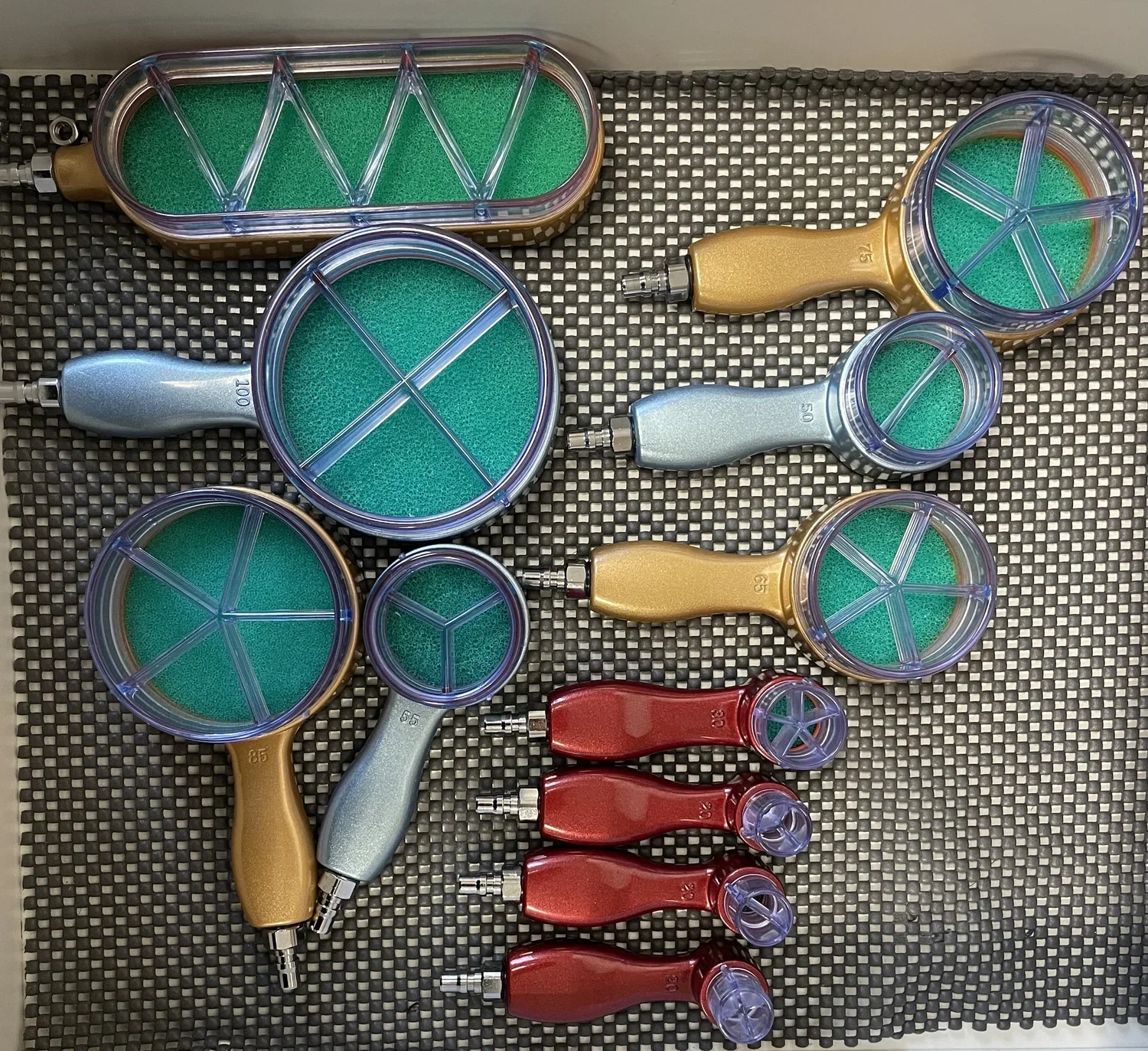 Electronic cupping tools laid out on a surface for display.