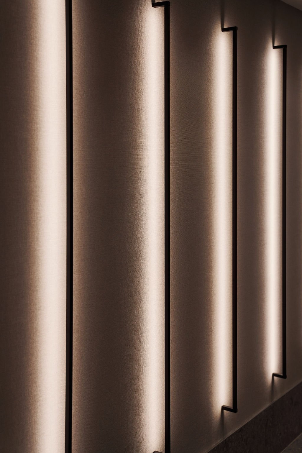 Close-up of a modern wall with vertical metallic panels and integrated lighting creating a sleek, contemporary look.