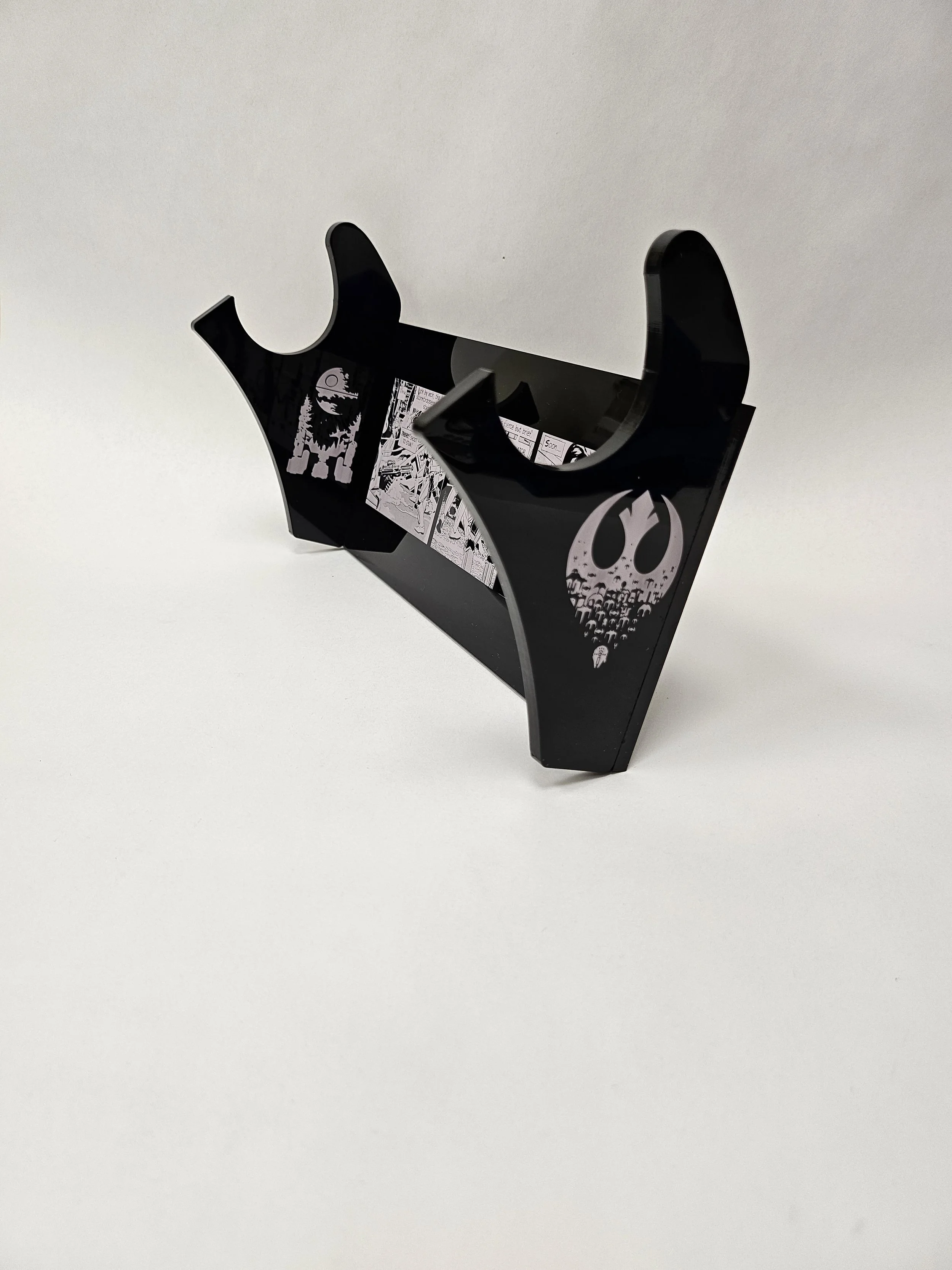 Right side view of black acrylic light saber mount with images of R2D2 and the Rebel Alliance logo with a comic strip of Darth Vader.