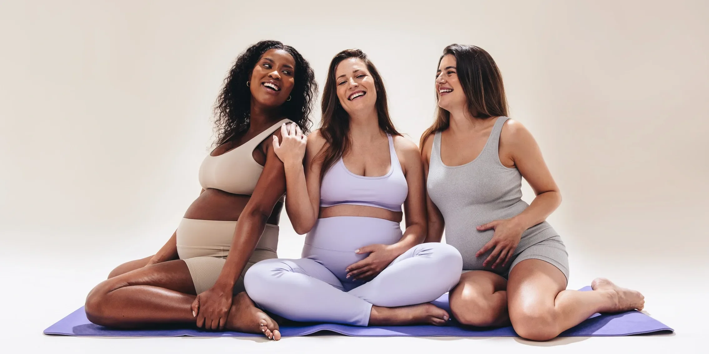 three pregnant surrogates sitting together smiling