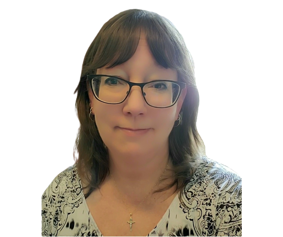 A woman with glasses, shoulder-length brown hair, wearing earrings, a patterned top, and a cross necklace.