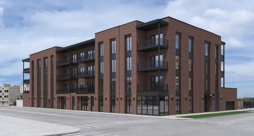 Newly constructed modern brick apartment building with multiple balconies on a city street