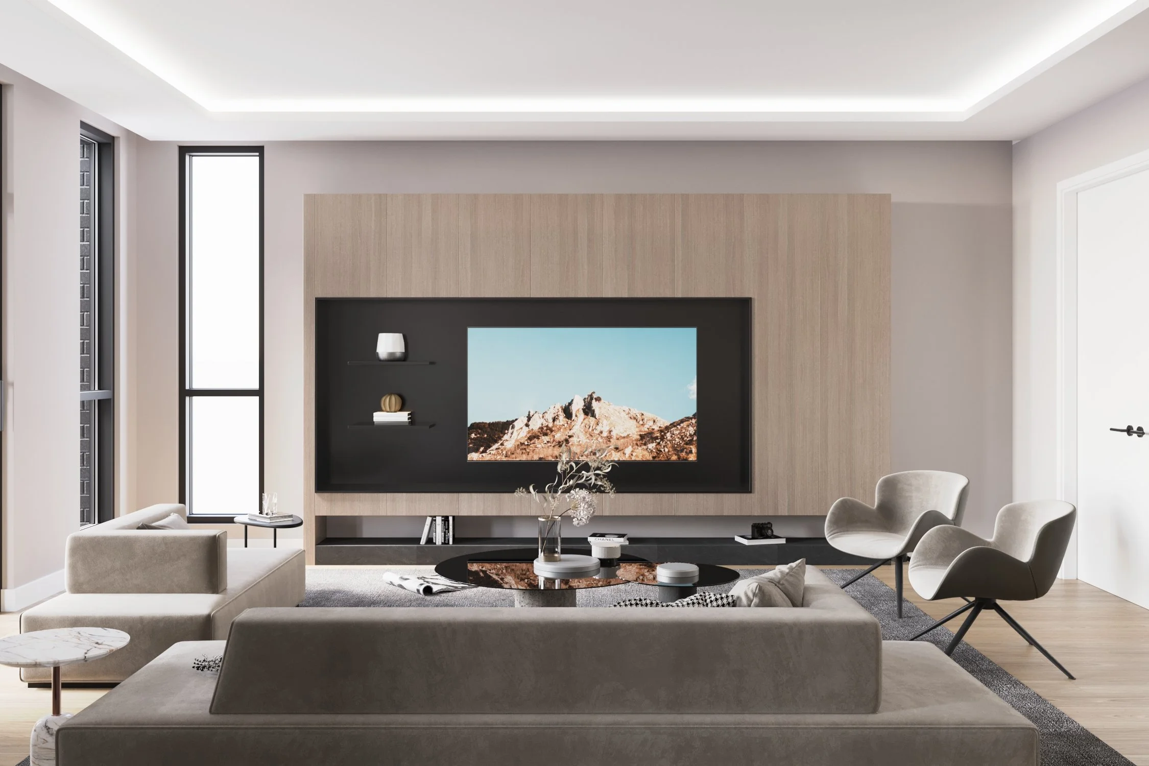 Modern living room with a large flat-screen TV, beige sofas, two armchairs, a black coffee table, and a wood accent wall, illuminated by natural light from tall windows.