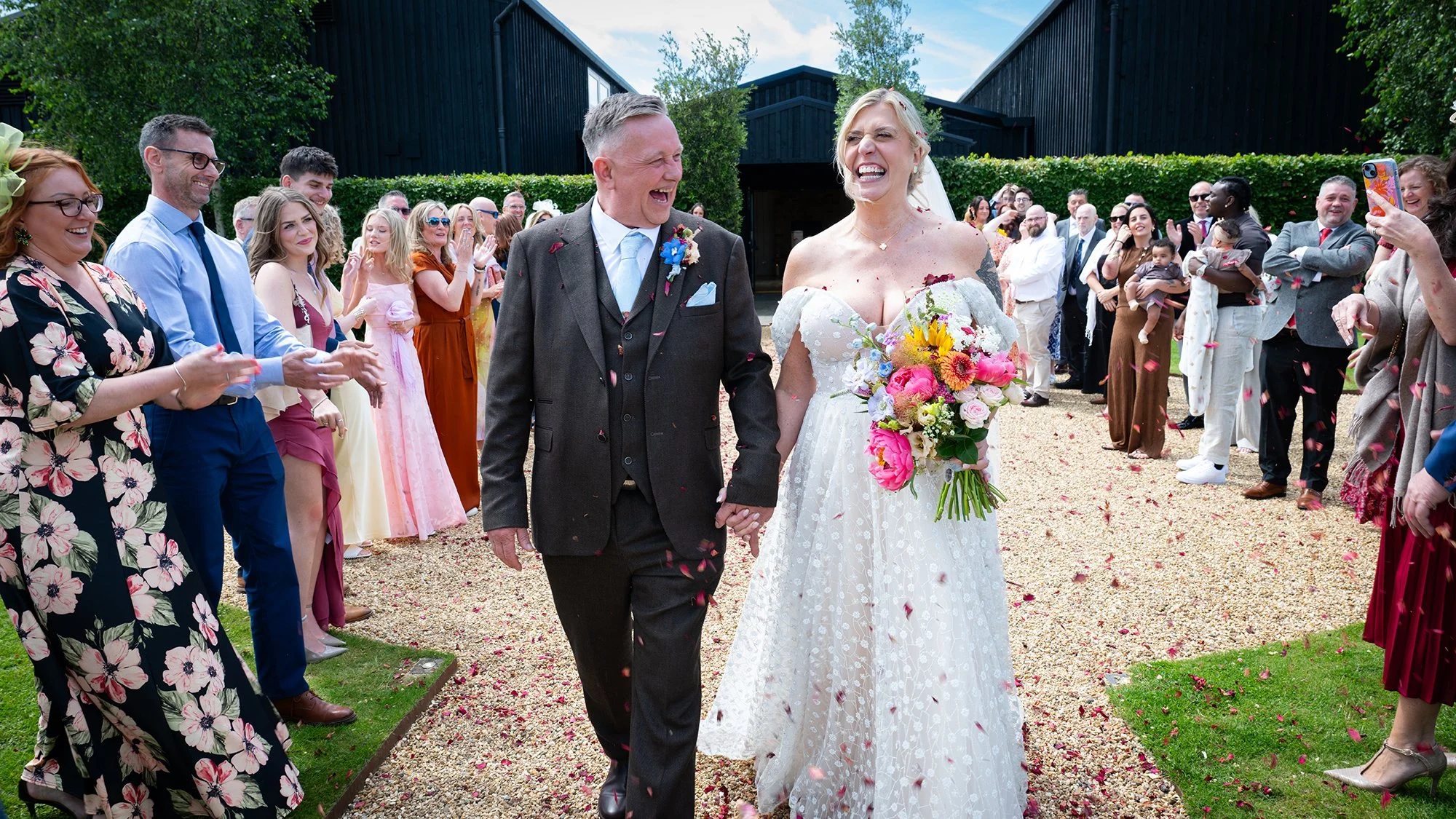 bride and groom walking through confetti
