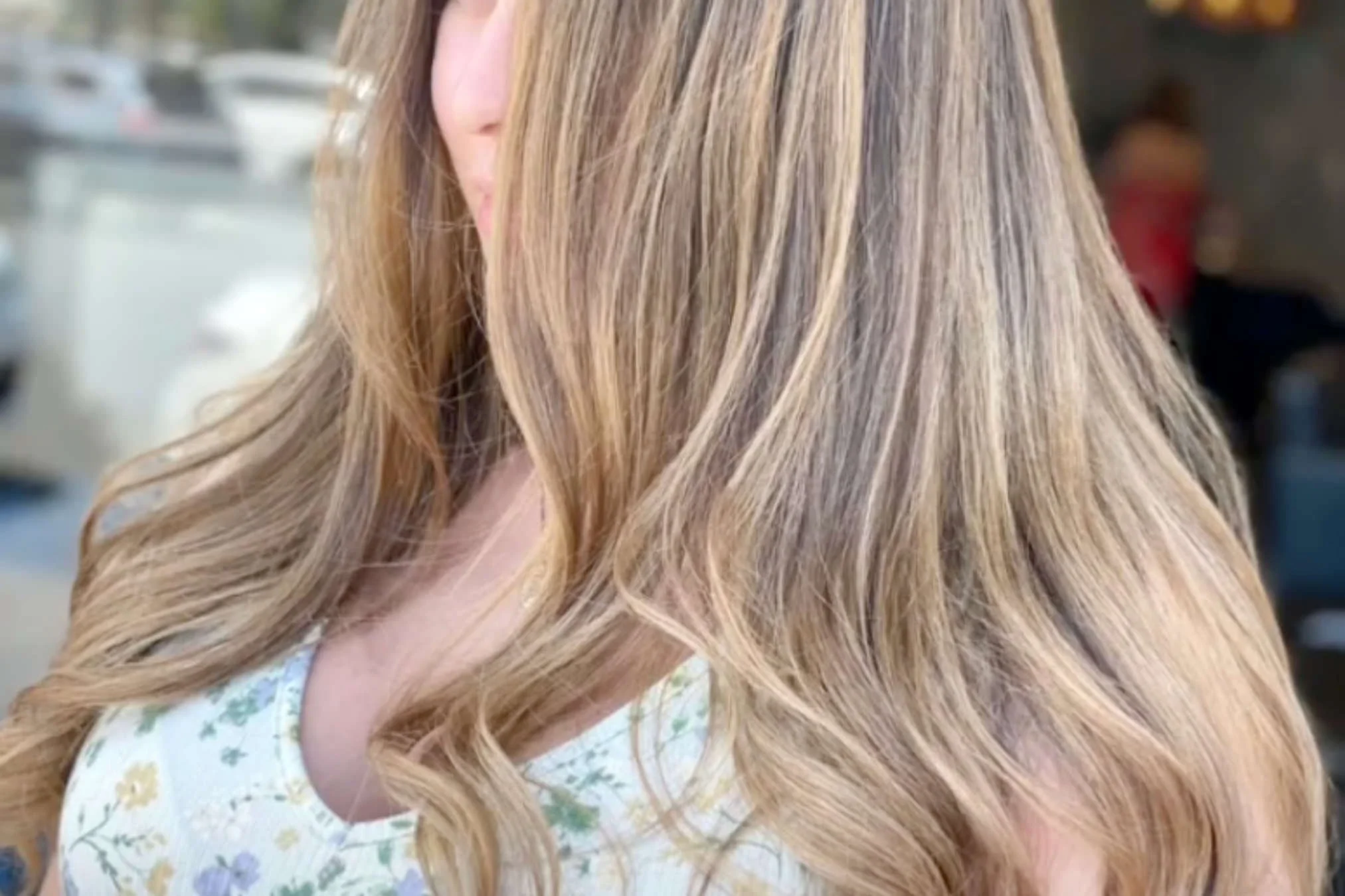 Balayage color result at Willow's Cove Salon in Mineola NY — hand-painted highlights on long wavy blonde hair with soft, blended dimension