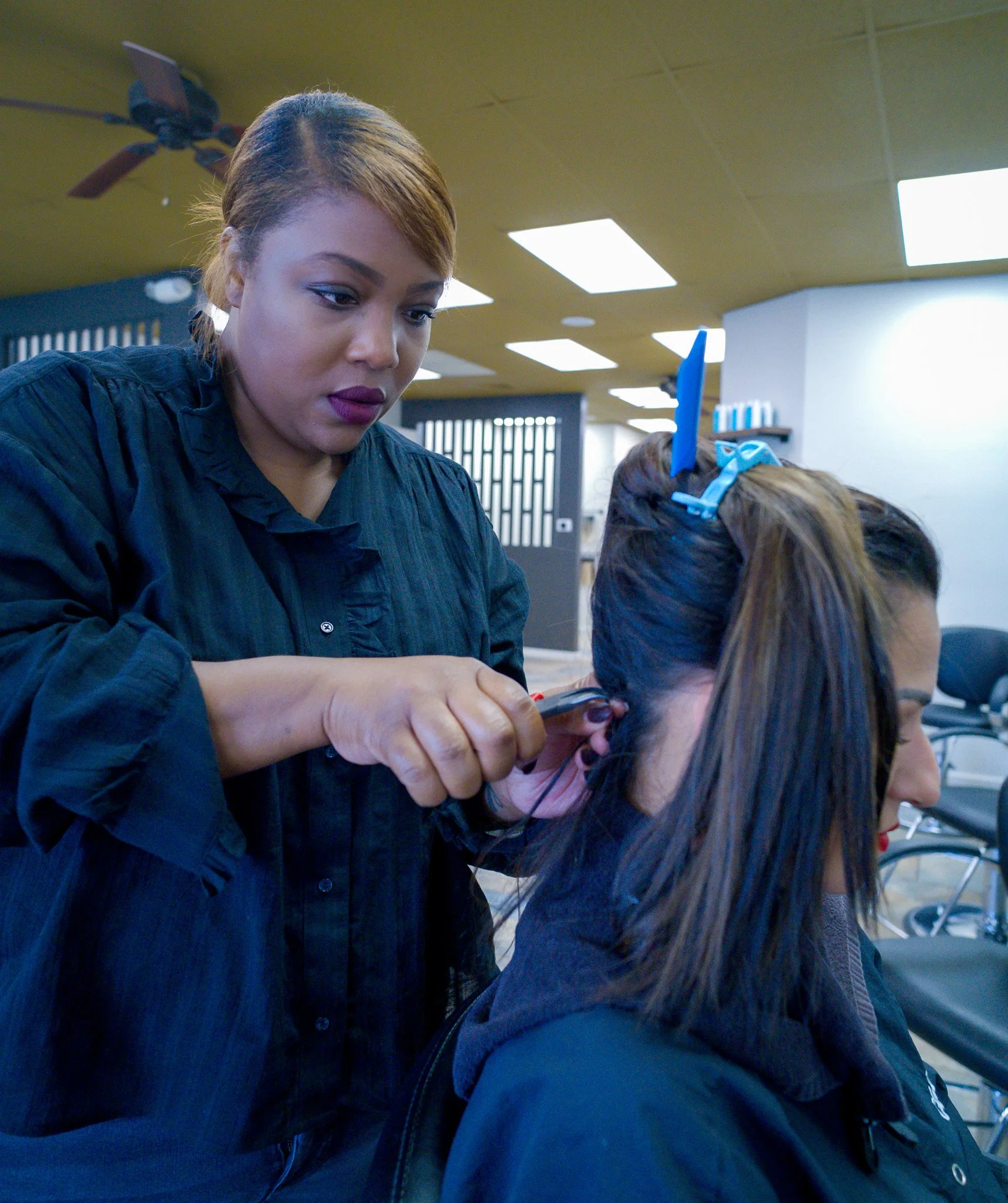 Stylist cutting a client's hair at Willow's Cove Salon in Mineola, NY