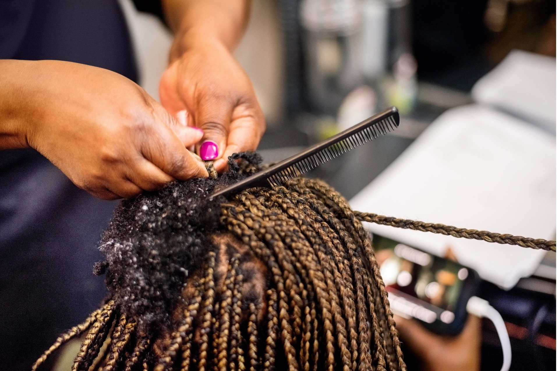 Stylist installing crochet braids on a client at Willow's Cove Salon