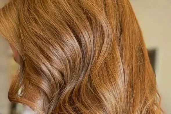 Single process color result at Willow's Cove Salon in Mineola NY — medium length wavy hair with warm copper tone and even, refreshed color