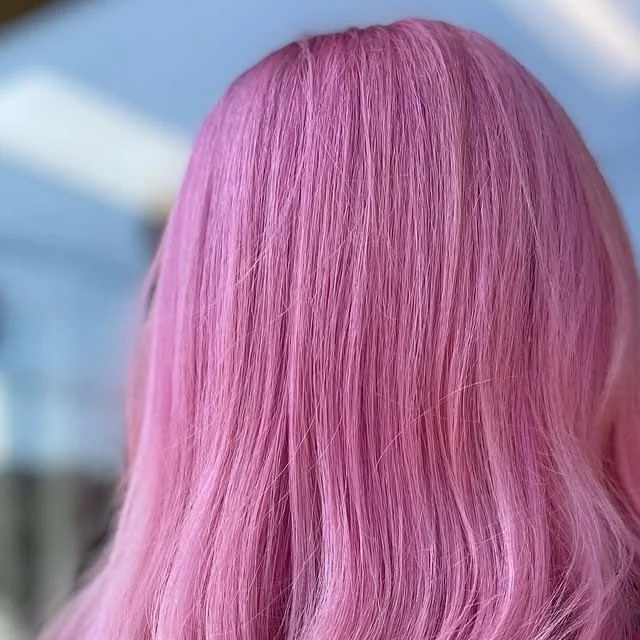 Hair gloss treatment result at Willow's Cove Salon in Mineola NY — vibrant pink hair with high-shine finish and smooth, sealed cuticle