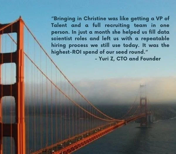 A view of the Golden Gate Bridge partially shrouded in fog over San Francisco Bay.