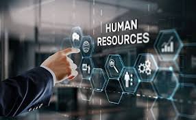 A person in a suit points at a virtual screen displaying human resources icons and text.