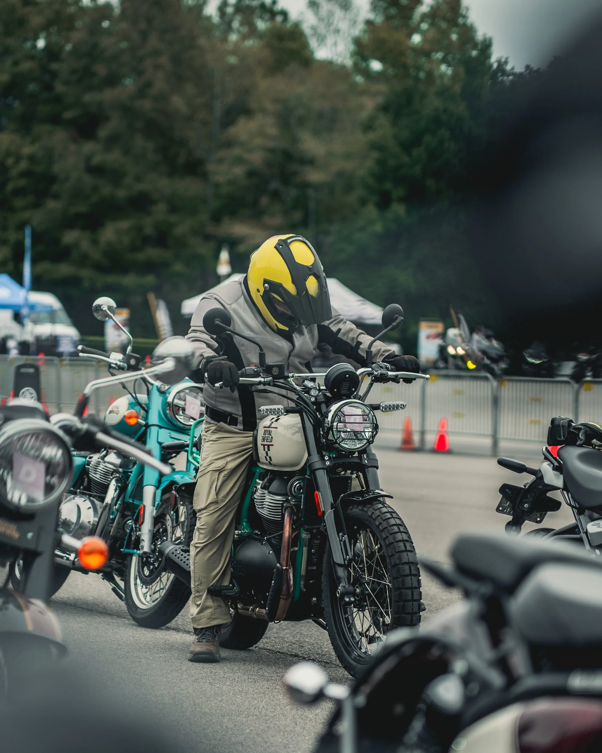 Rider in a yellow helmet on a Royal Enfield at Barber Vintage Festival