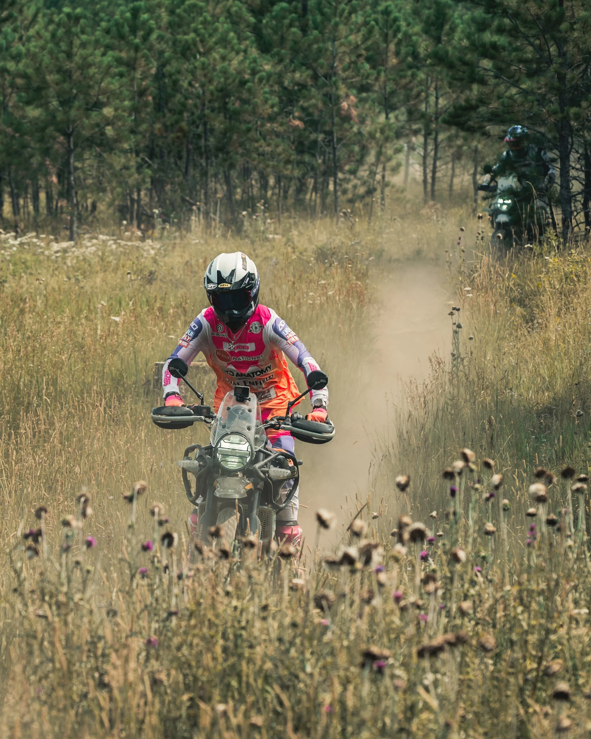 Rider racing through tall grass on a dirt bike at Sturgis 2026