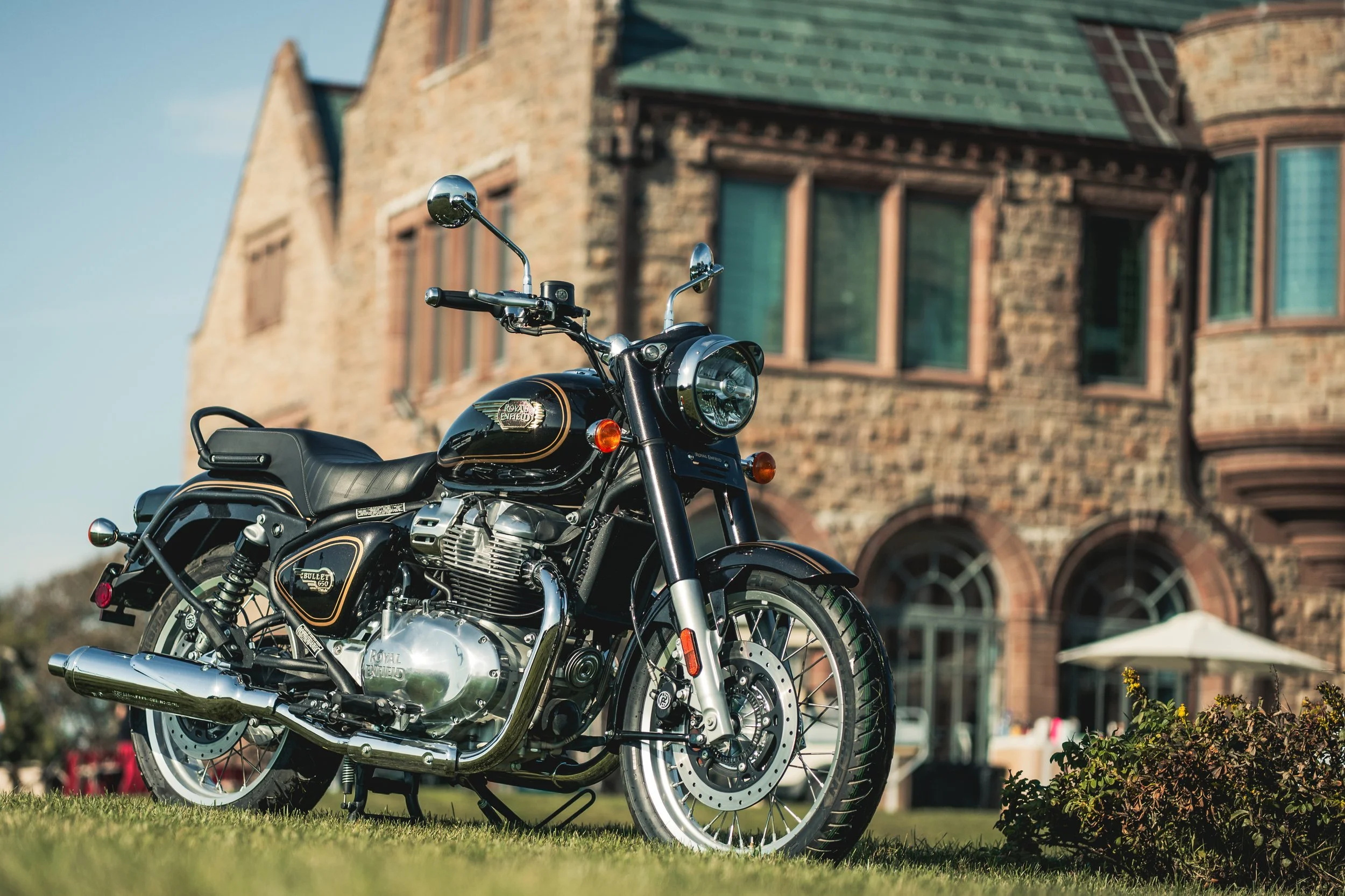 Royal Enfield Bullet 650 parked in front of a historic mansion at Audrain