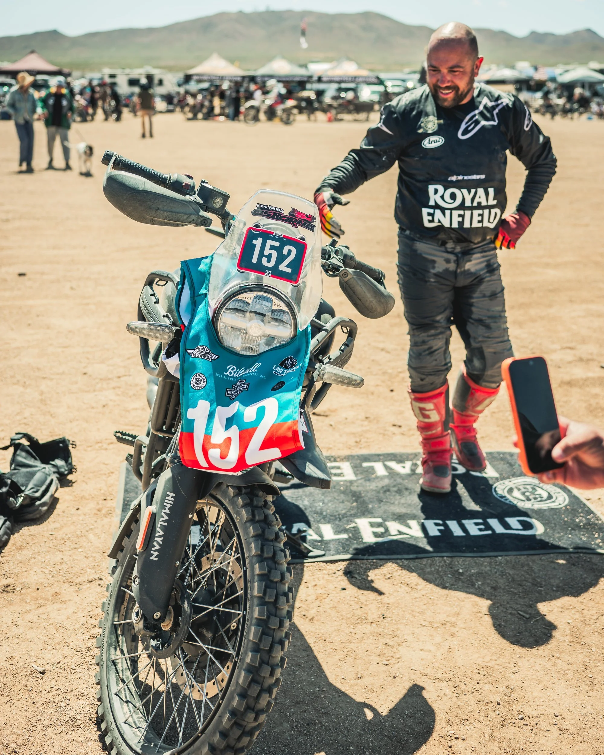 Royal Enfield racer standing behind his number 162 bike at the Biltwell 100