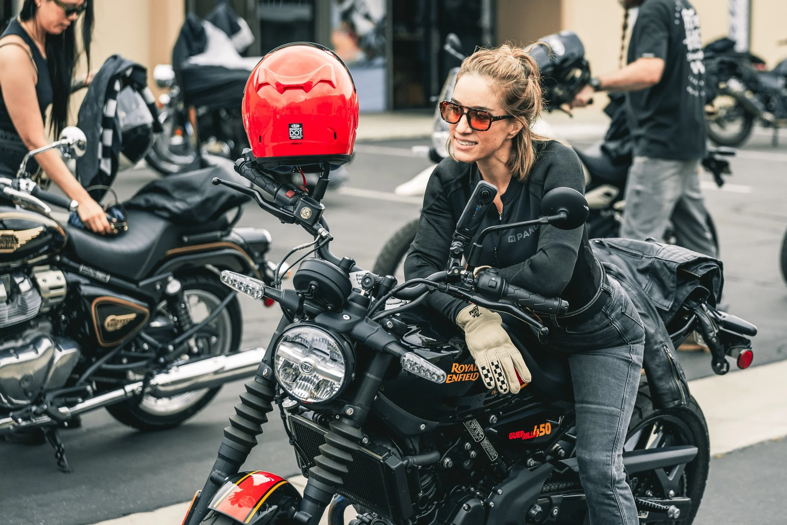 Rider smiling on her Royal Enfield at One Ride 2026