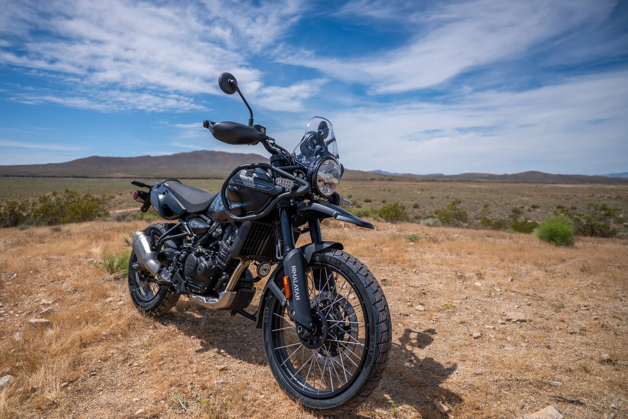 Royal Enfield Himalayan 450 Mana Black on a desert trail under blue sky