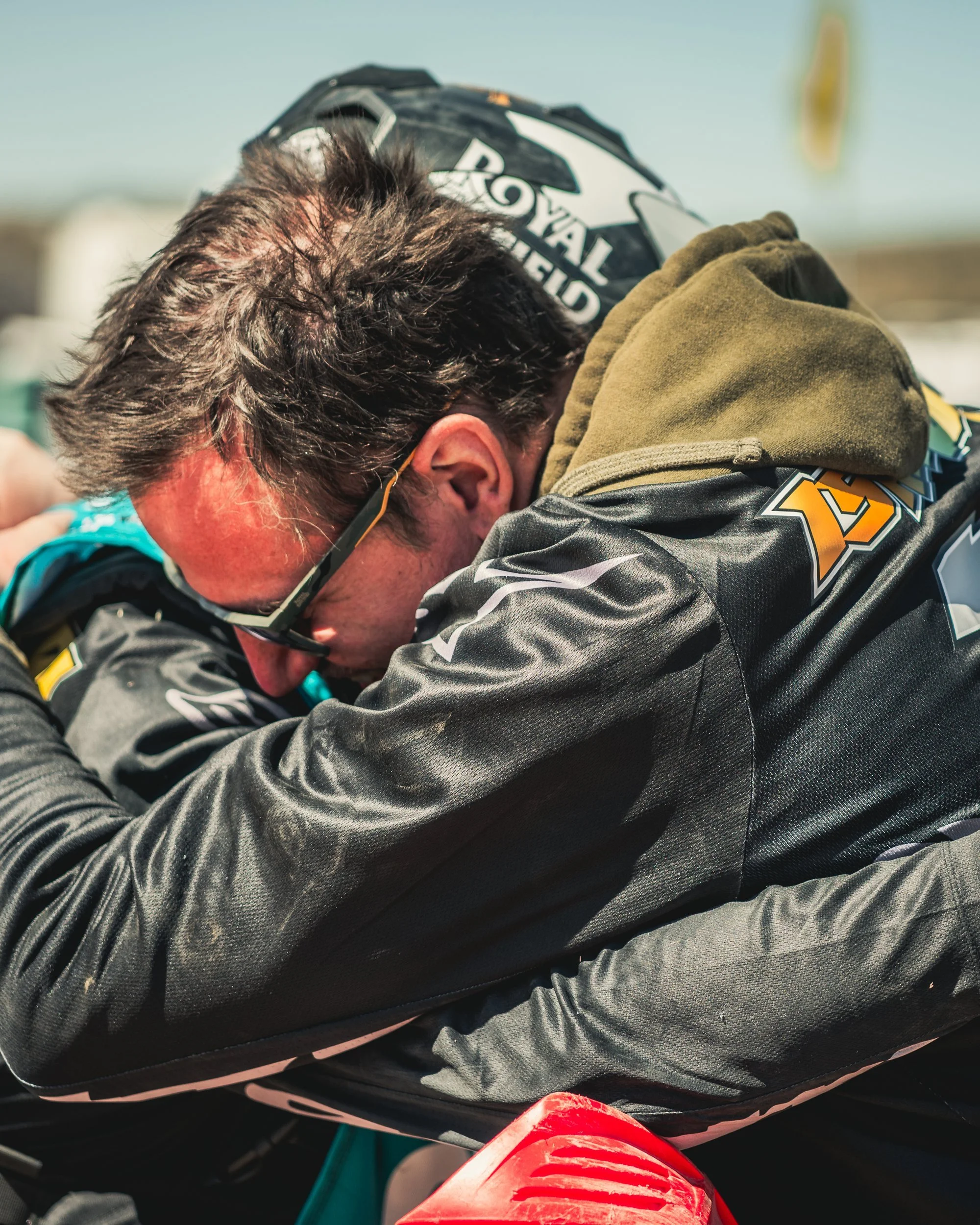 Royal Enfield racers embracing after the Biltwell 100