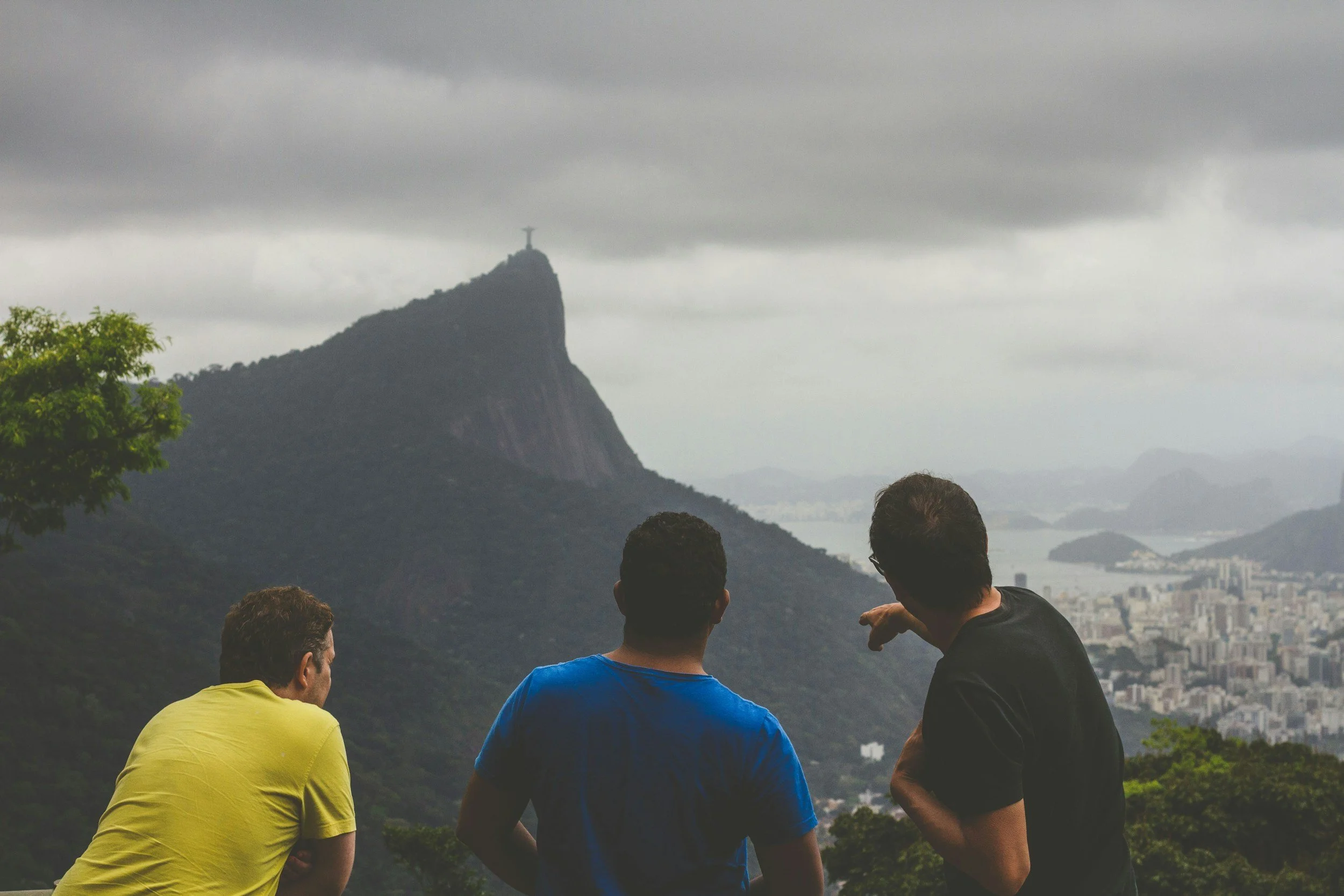 Image of a guide in front of a mountain with another man