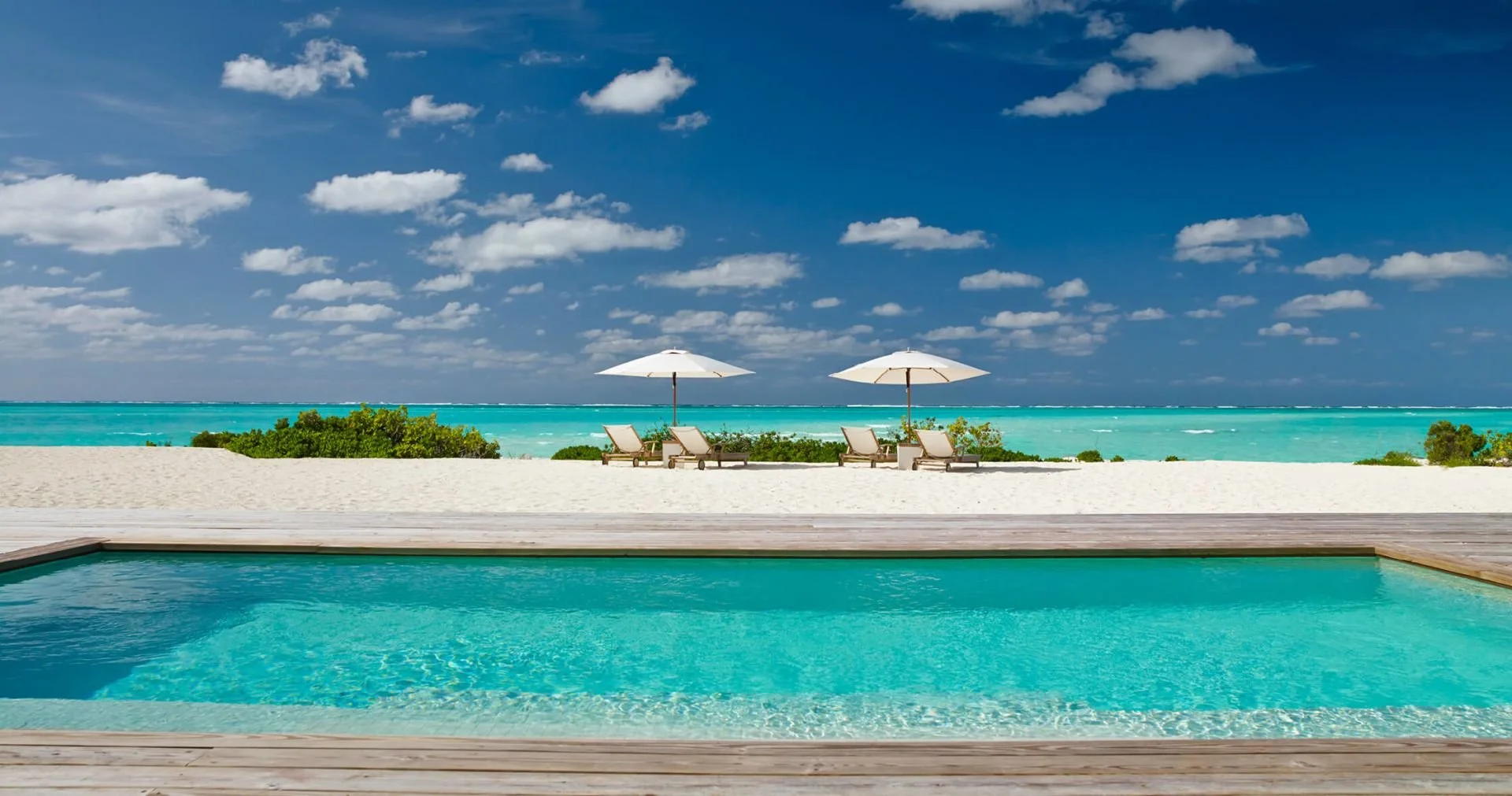 COMO Parrot Cay private pool with white sand beach and turquoise Caribbean ocean Turks and Caicos