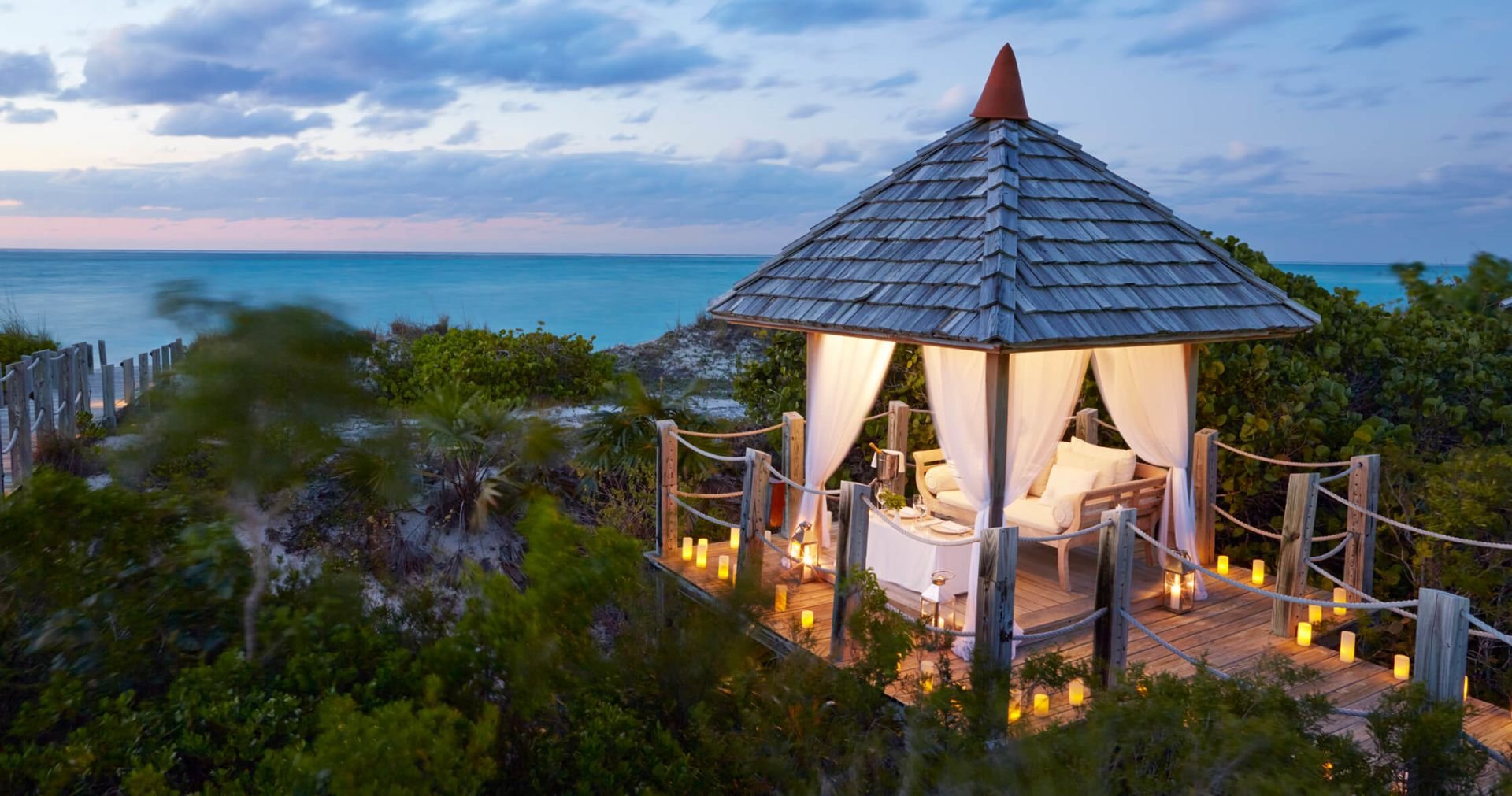 COMO Parrot Cay private candlelit beach cabana at sunset Turks and Caicos romantic dining
