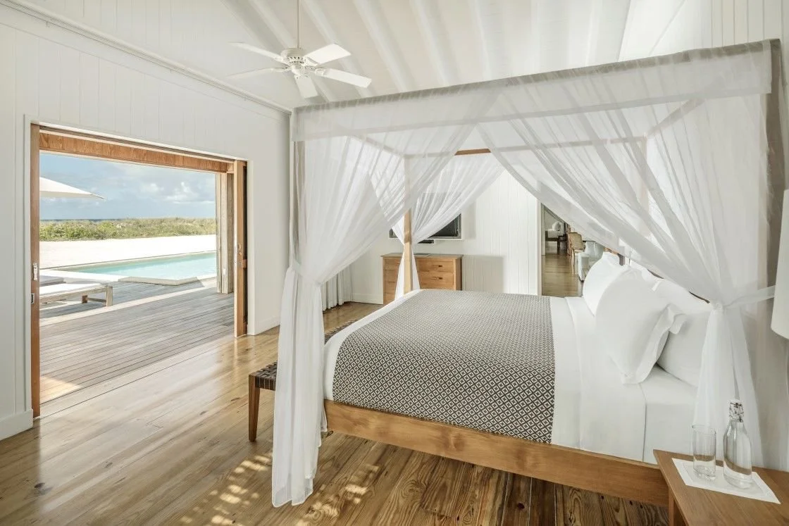 COMO Parrot Cay Beach House bedroom with four poster bed and private pool view Turks and Caicos