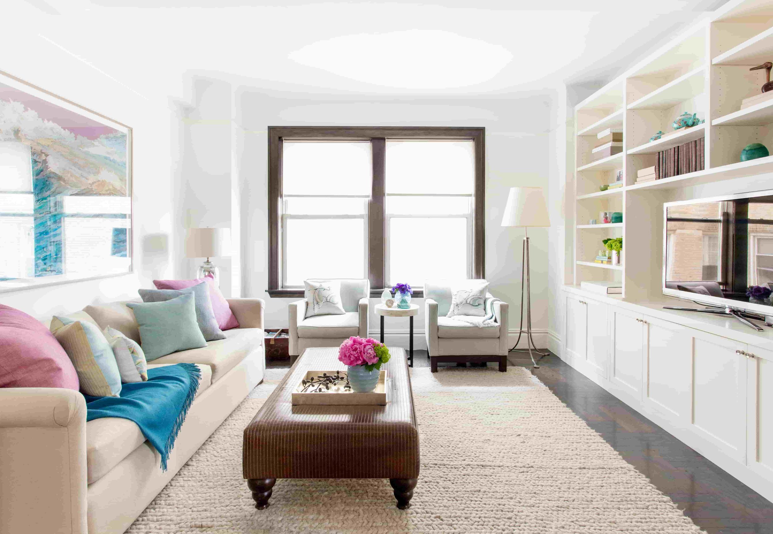 A living room with a wall of cabinetry designed by caroline kopp interior design