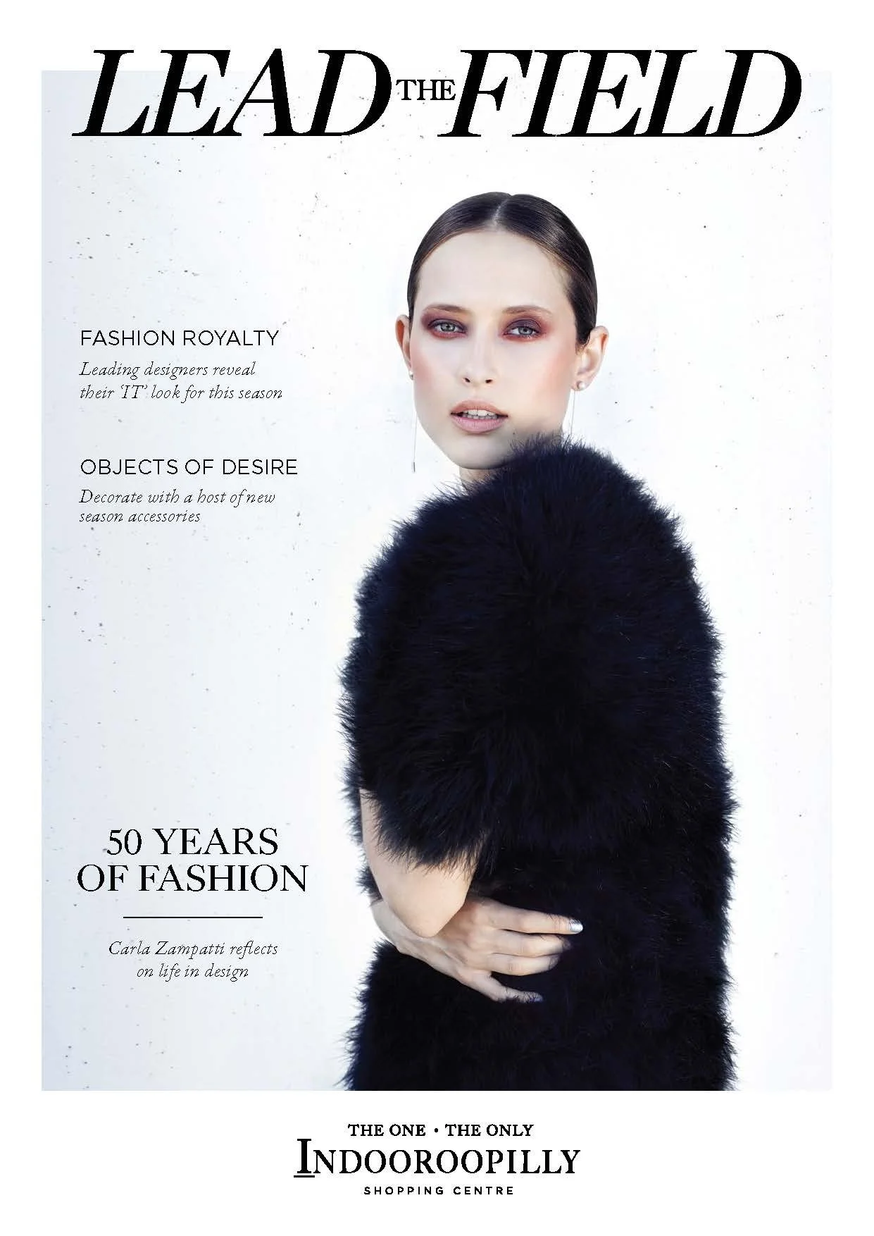 Magazine cover titled 'Lead the Field' featuring a woman with dark hair in a sleek hairstyle, wearing a black furry garment, against a white background with black text about fashion and design.