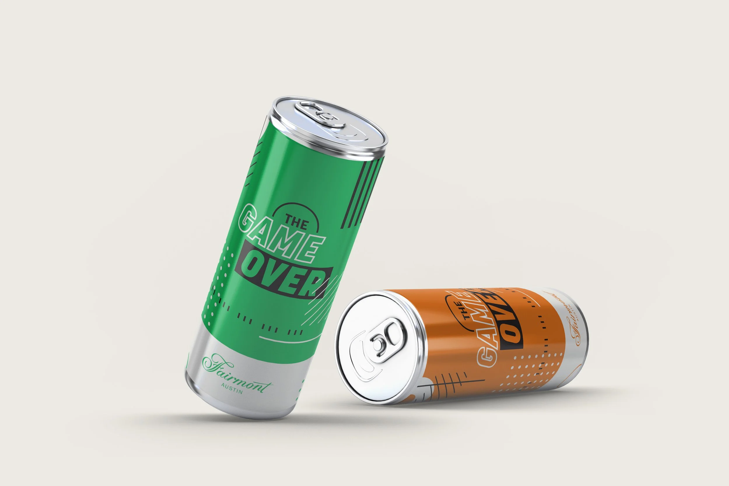 Two cans with the words 'The Game Over' on the labels, one green and one orange, placed on a light background.