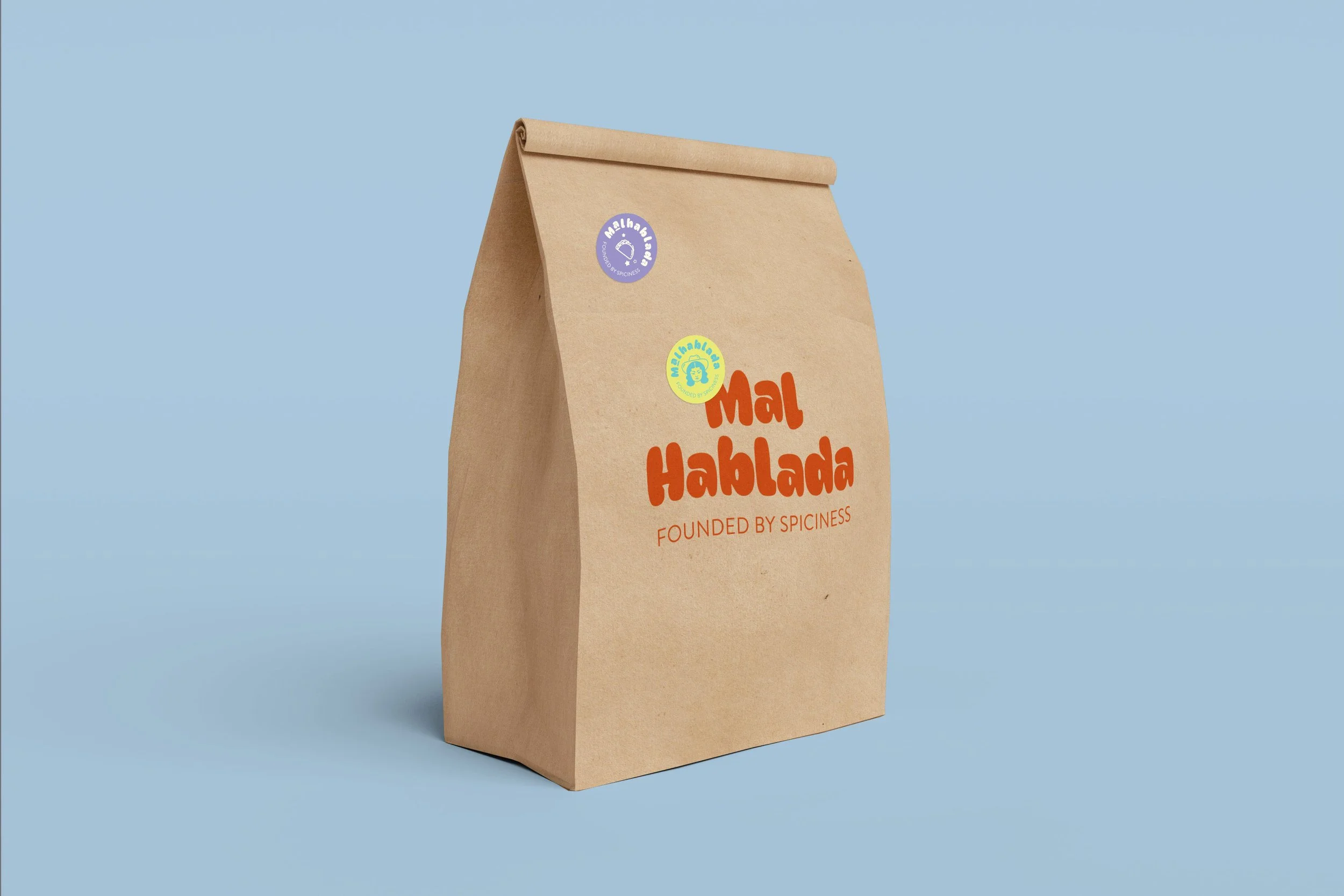 A brown paper bag with the logo 'Mal Hablada' printed on it, standing against a light blue background.