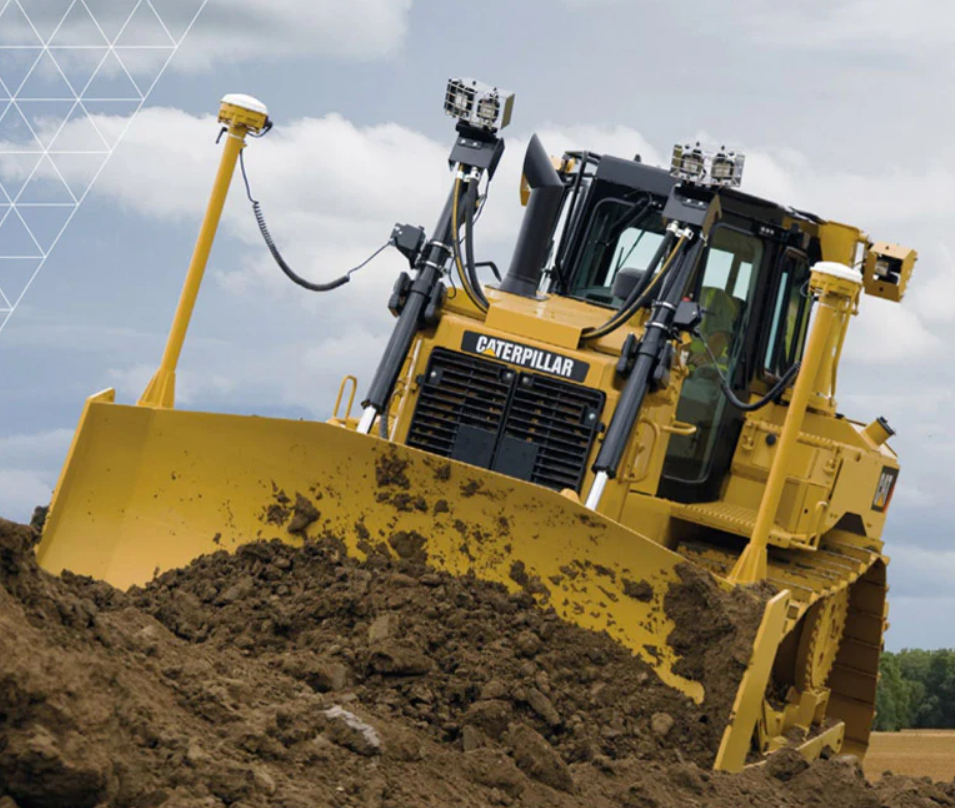 A large yellow Caterpillar bulldozer pushing a mound of dirt outdoors.