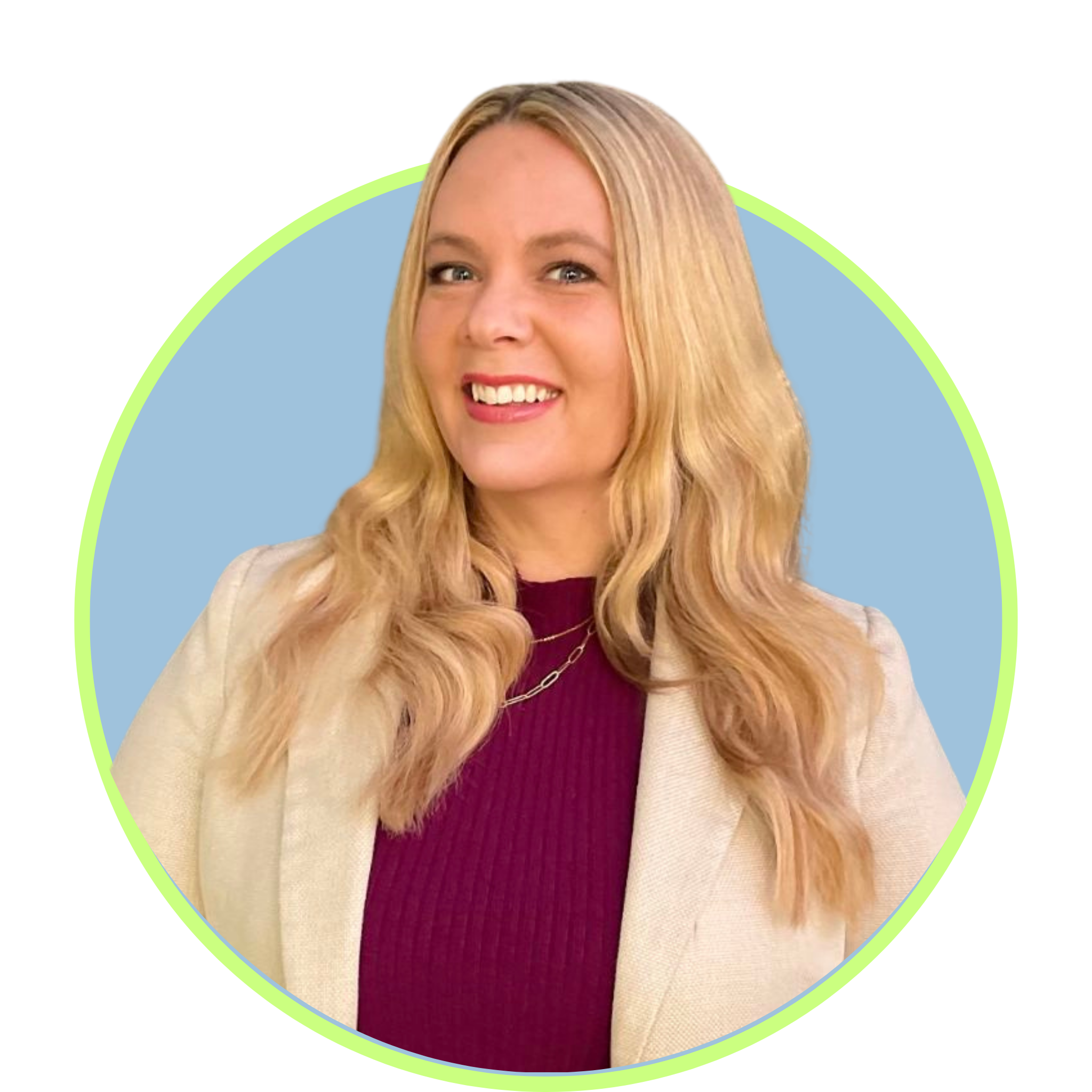 A smiling woman with long blonde hair wearing a beige blazer and a burgundy top.