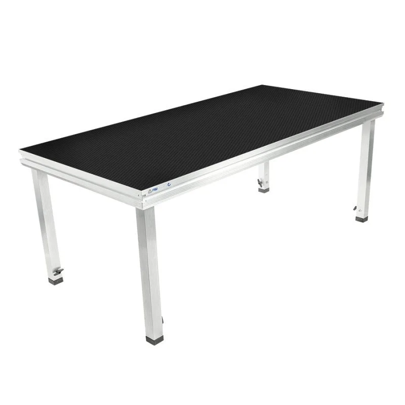 Table de travail avec une surface noire et des pieds en métal blanc.