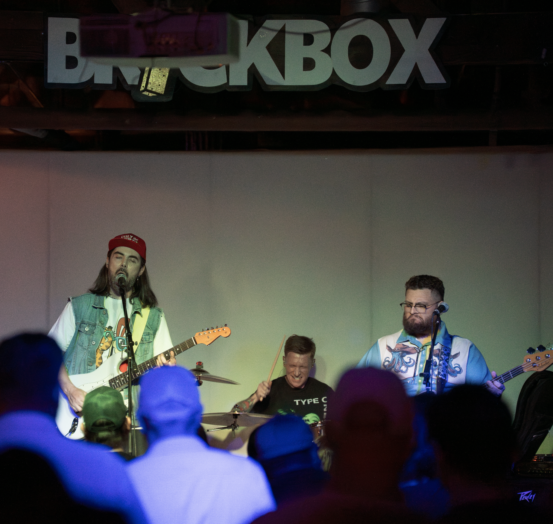 Tucson band performing live on stage at a venue that appears to be called Brick Box.