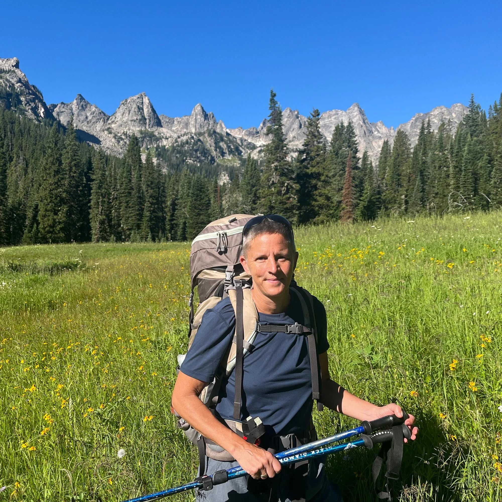 Janet outdoors with mountains behind her