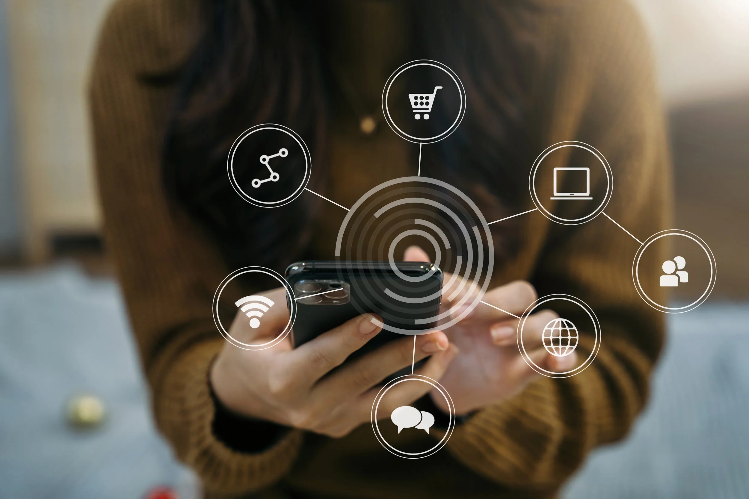 Person holding a smartphone with digital icons representing networking, shopping, and internet connectivity overlayed.