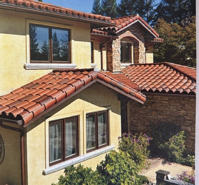 Mediterranean-style villa tile, cream stucco walls and arched windows