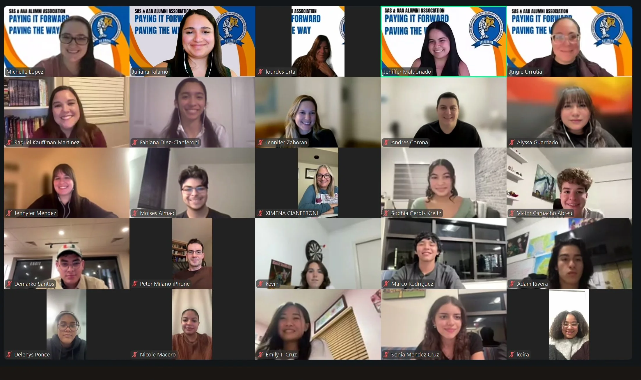 Screenshot of a virtual meeting with multiple young adults, some smiling, and group banners in the background that say 'SAS & AAA ALUMNI ASSOCIATION PAYING IT FORWARD PAVING THE WAY'.