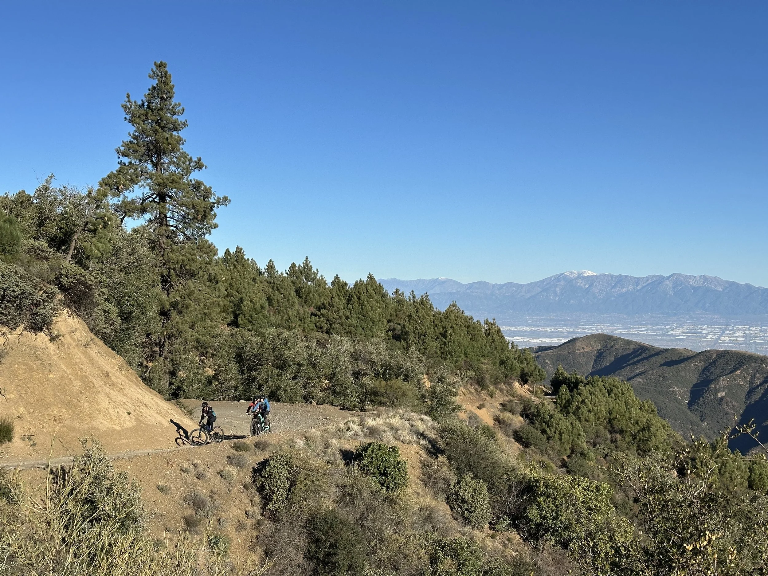 Riders coming up Maple Springs Road with snow capped Mount Baldy of the San Gabriels dwarfing our Santa Ana peaks.