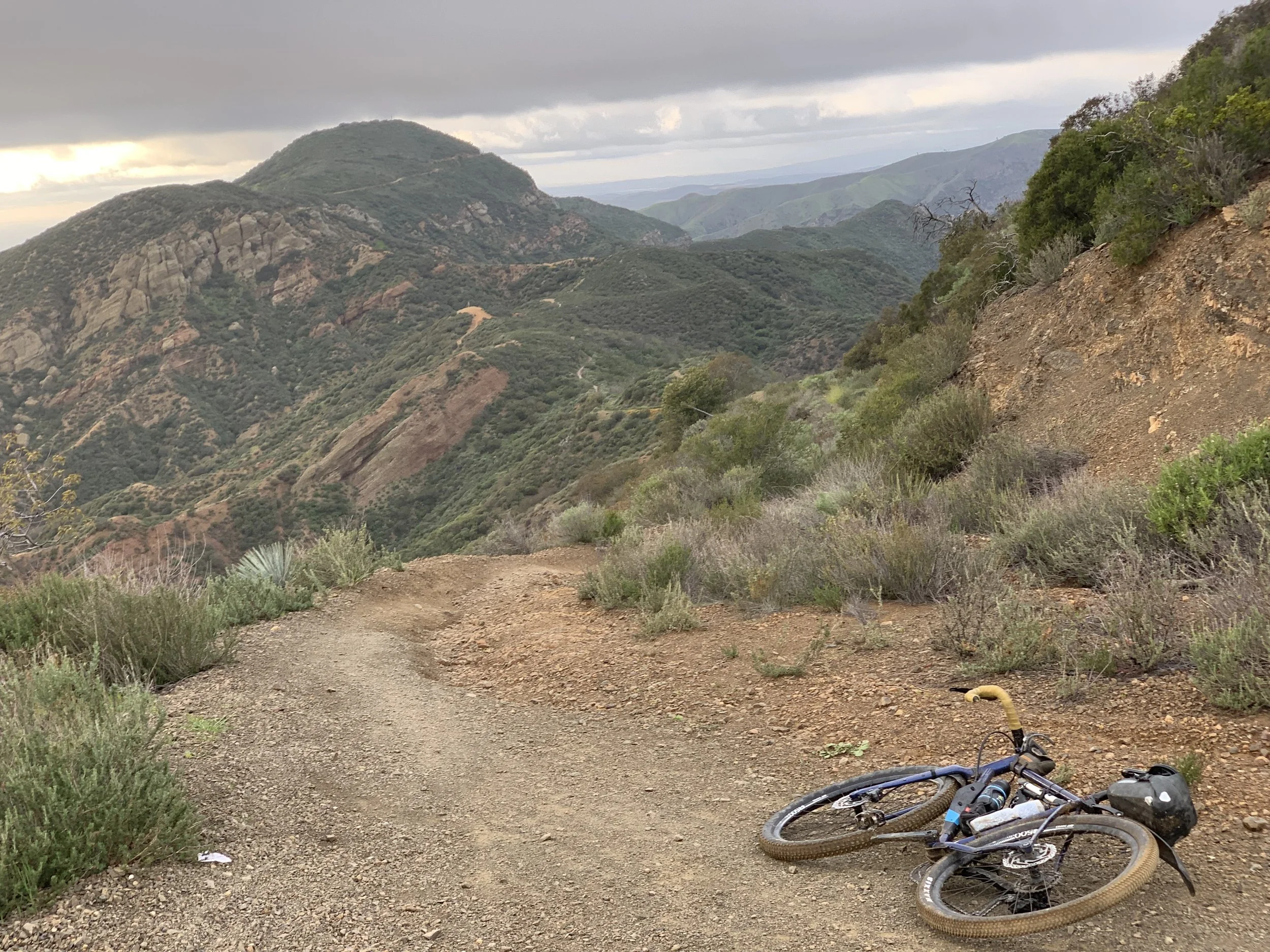 After descending Joplin, return to fire road on Santiago Truck Trail with Vulture Crags and the next singletrack, The Luge, ahead.