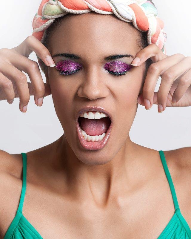 Model wearing bold, colorful eye makeup and a patterned headscarf, styled for a fashion editorial by Spokane and Coeur d’Alene bridal hair and makeup artist Terri Reece Studios.