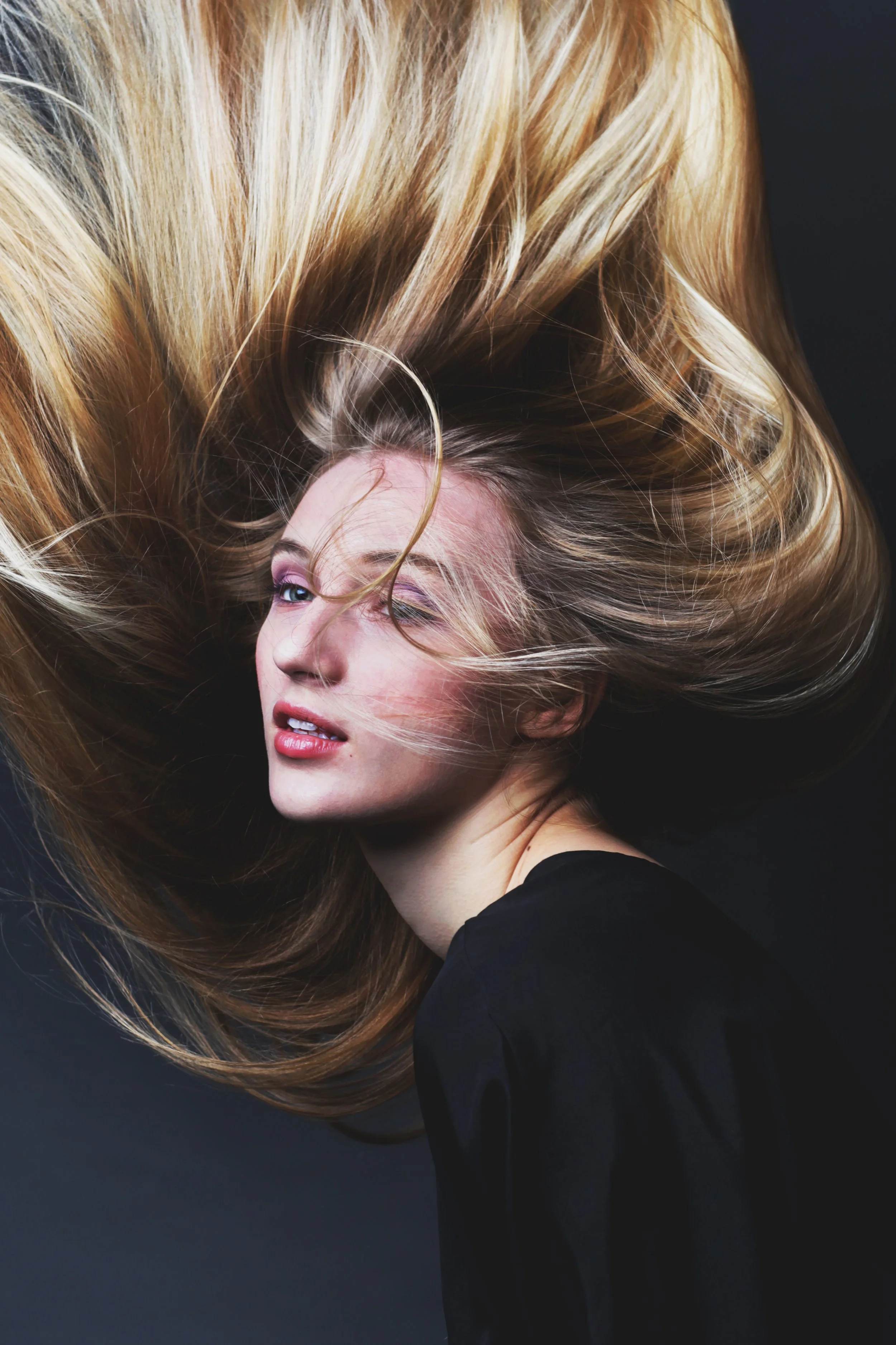 Editorial shot of a blonde model with dramatic, voluminous hair and soft glam makeup, styled by Spokane and Coeur d’Alene bridal hair and makeup artist Terri Reece Studios.