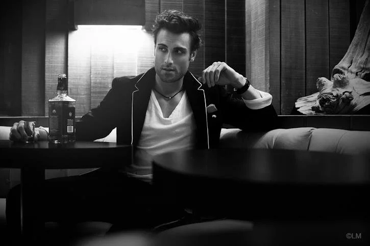 Black-and-white editorial portrait of a man in a suit, featuring clean grooming and styling by Spokane and Coeur d’Alene bridal hair and makeup artist Terri Reece Studios.