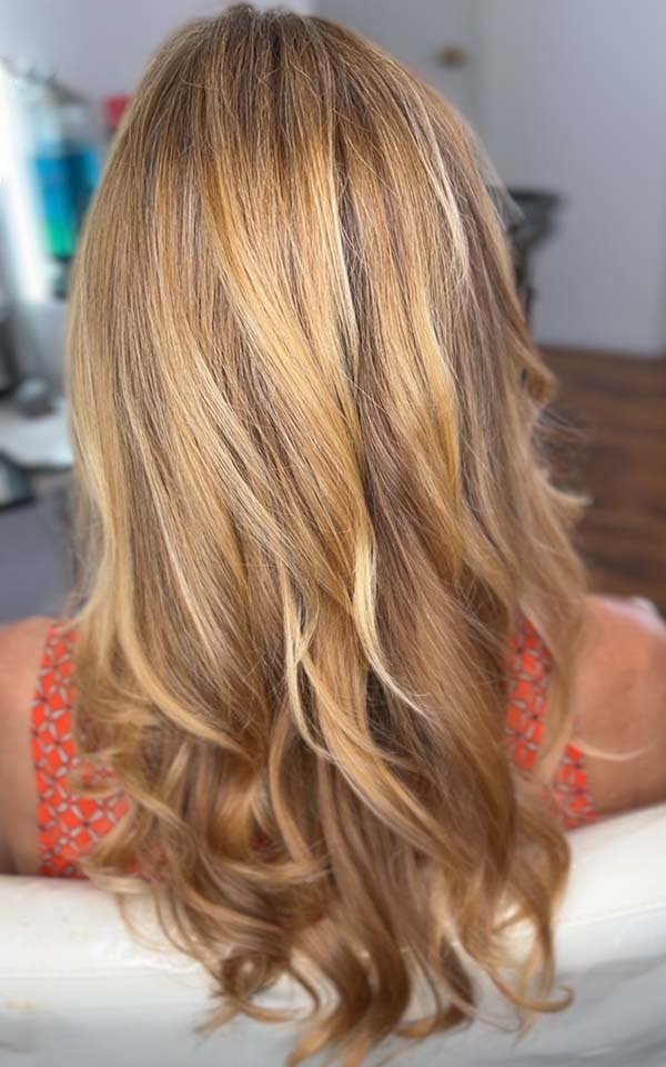 Soft waves in warm honey blonde hair