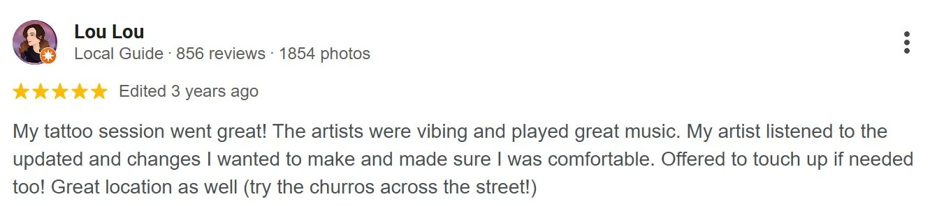 Screenshot of a Google review by Lou Lou for a tattoo session, featuring a five-star rating and review text about a positive experience with artists playing music and offering touch-up.