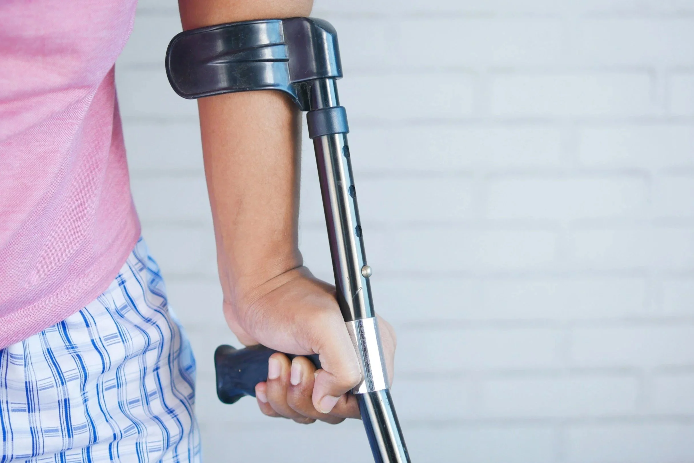 Man in pain with crutches 