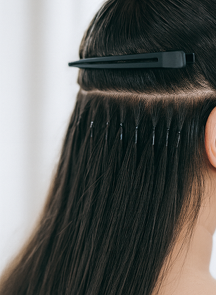 back of woman's head showing nano bead hair extensions