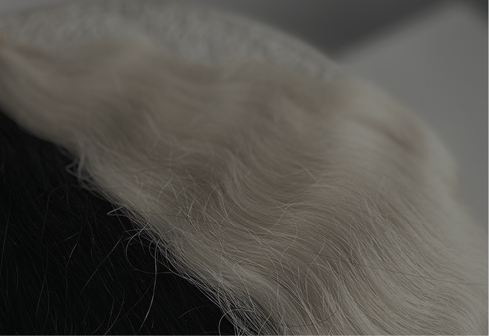 a dark overlay image of hair brown and blonde hair extensions on a table